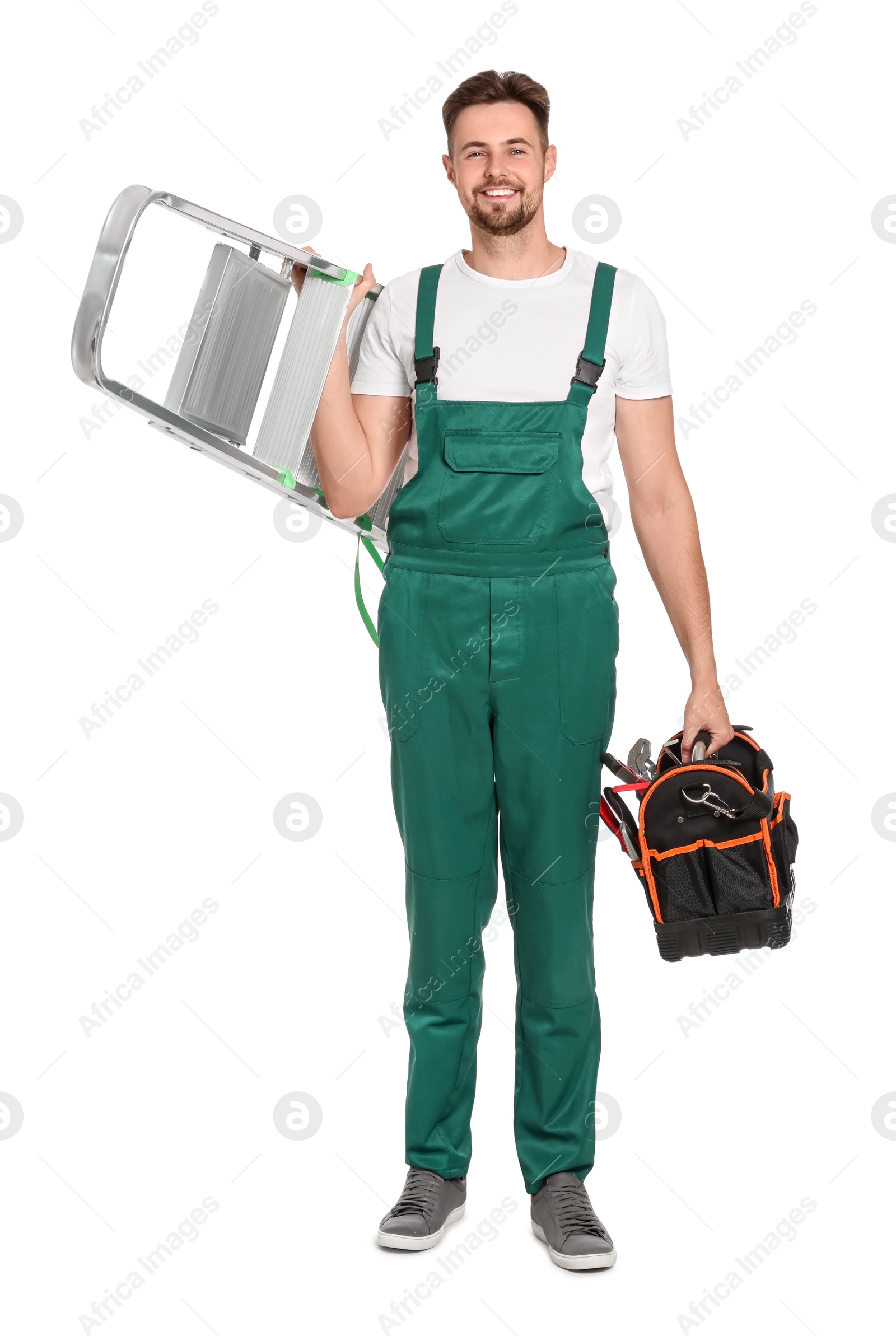 Photo of Worker in uniform holding metal ladder and instruments on white background