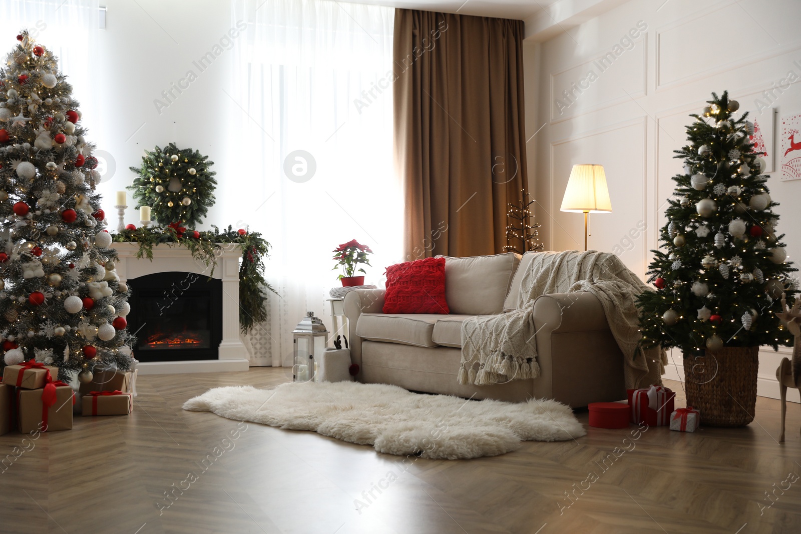 Photo of Festive living room interior with Christmas trees and fireplace