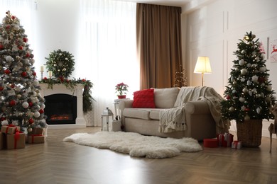 Photo of Festive living room interior with Christmas trees and fireplace