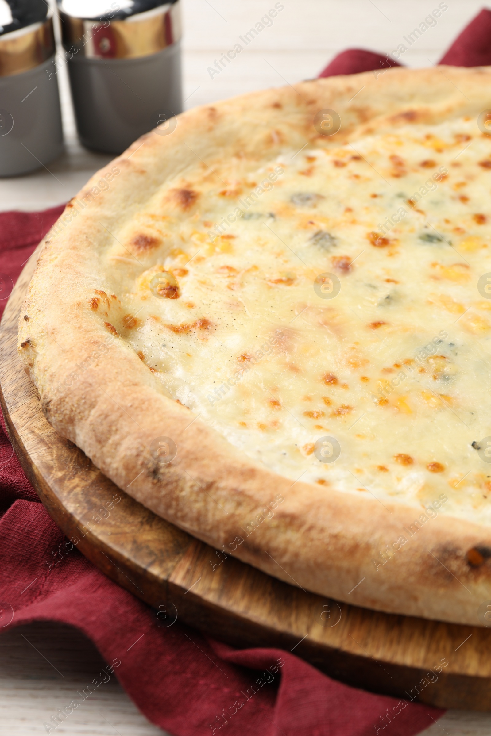 Photo of Delicious cheese pizza on white wooden table, closeup