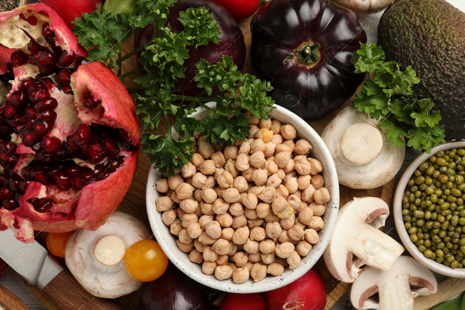 Photo of Different vegetables on wooden table, flat lay. Vegan diet