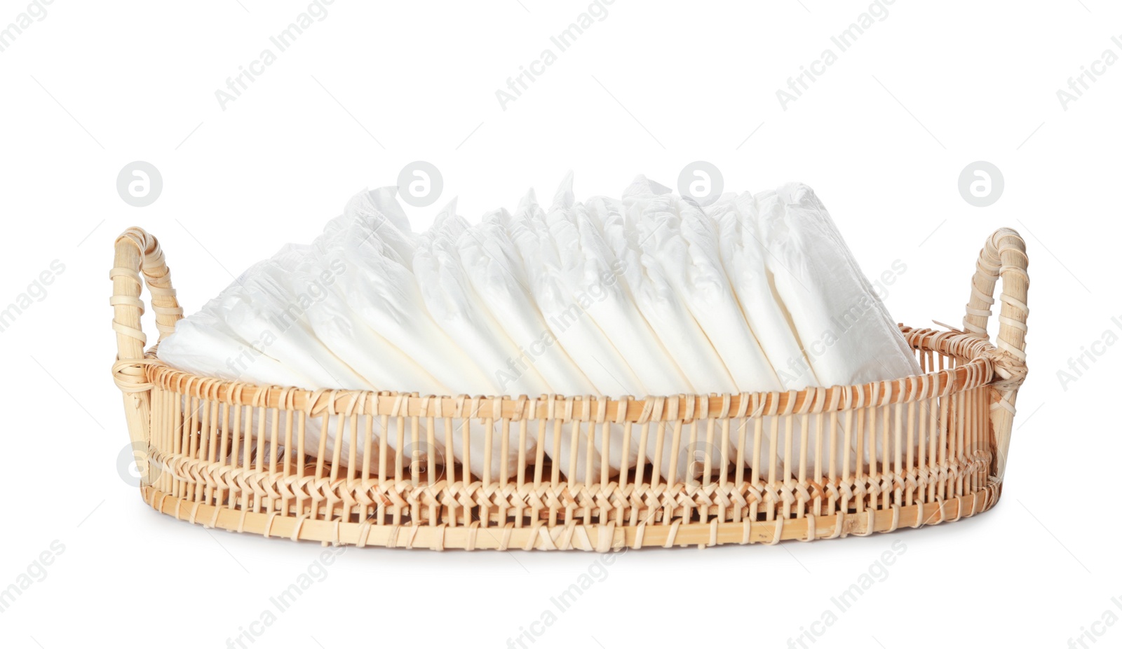 Photo of Wicker tray with disposable diapers isolated on white