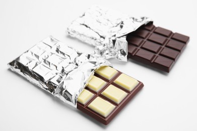 Photo of Two tasty chocolate bars on white background