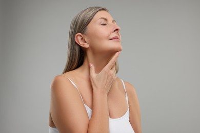 Photo of Beautiful woman with healthy skin on grey background