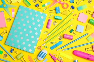 Flat lay composition with different school stationery on color background