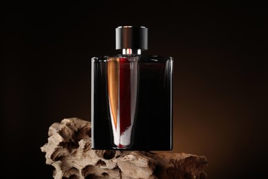 Photo of Luxury men`s perfume in bottle against dark background