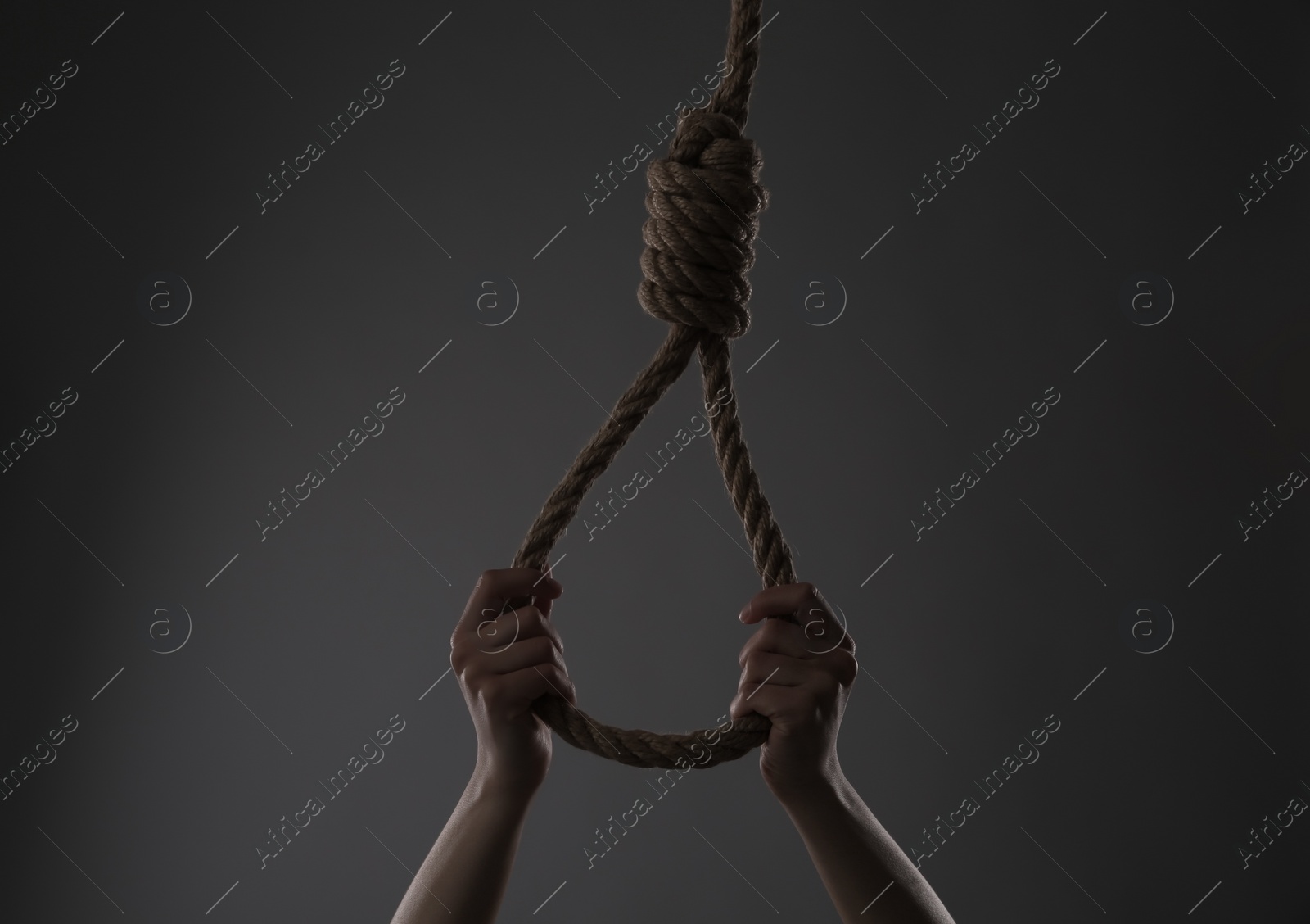 Photo of Woman holding rope noose on grey background, closeup