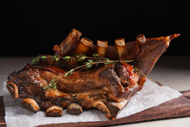 Photo of Delicious roasted ribs served on table, closeup