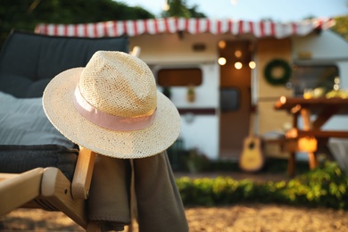 Photo of Hat on deck chair outdoors. Summer trip