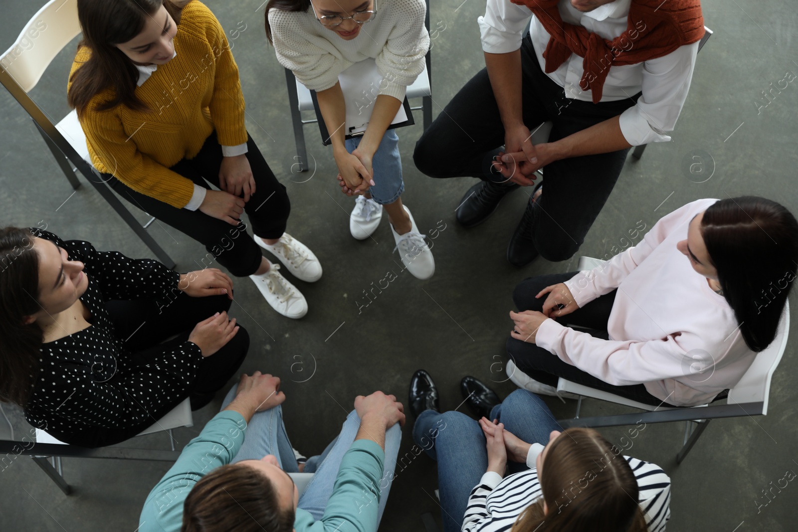 Photo of Psychotherapist working with patients in group therapy session, top view