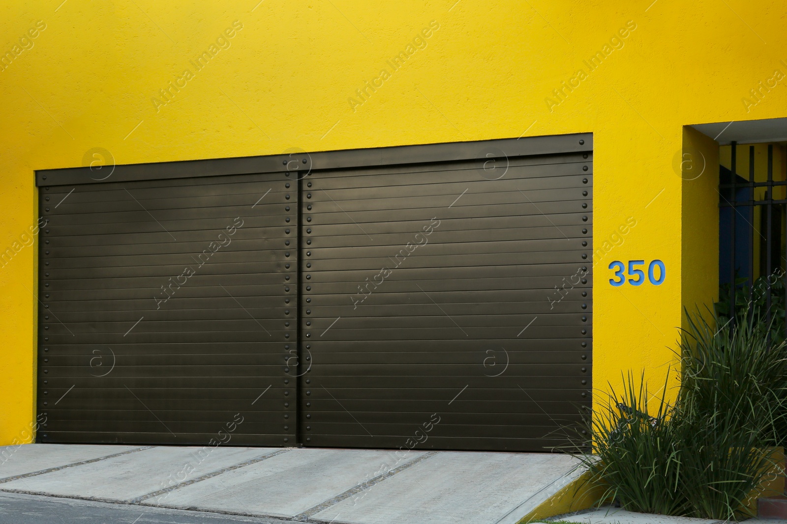 Photo of Closed gates of modern garage. Exterior design