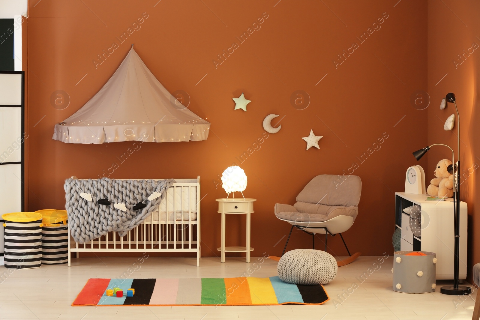 Photo of Stylish baby room interior with crib