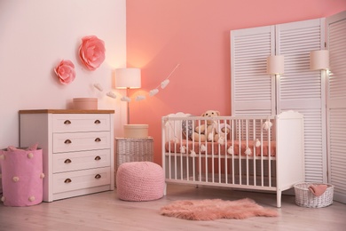 Photo of Baby room interior with decorations and comfortable crib