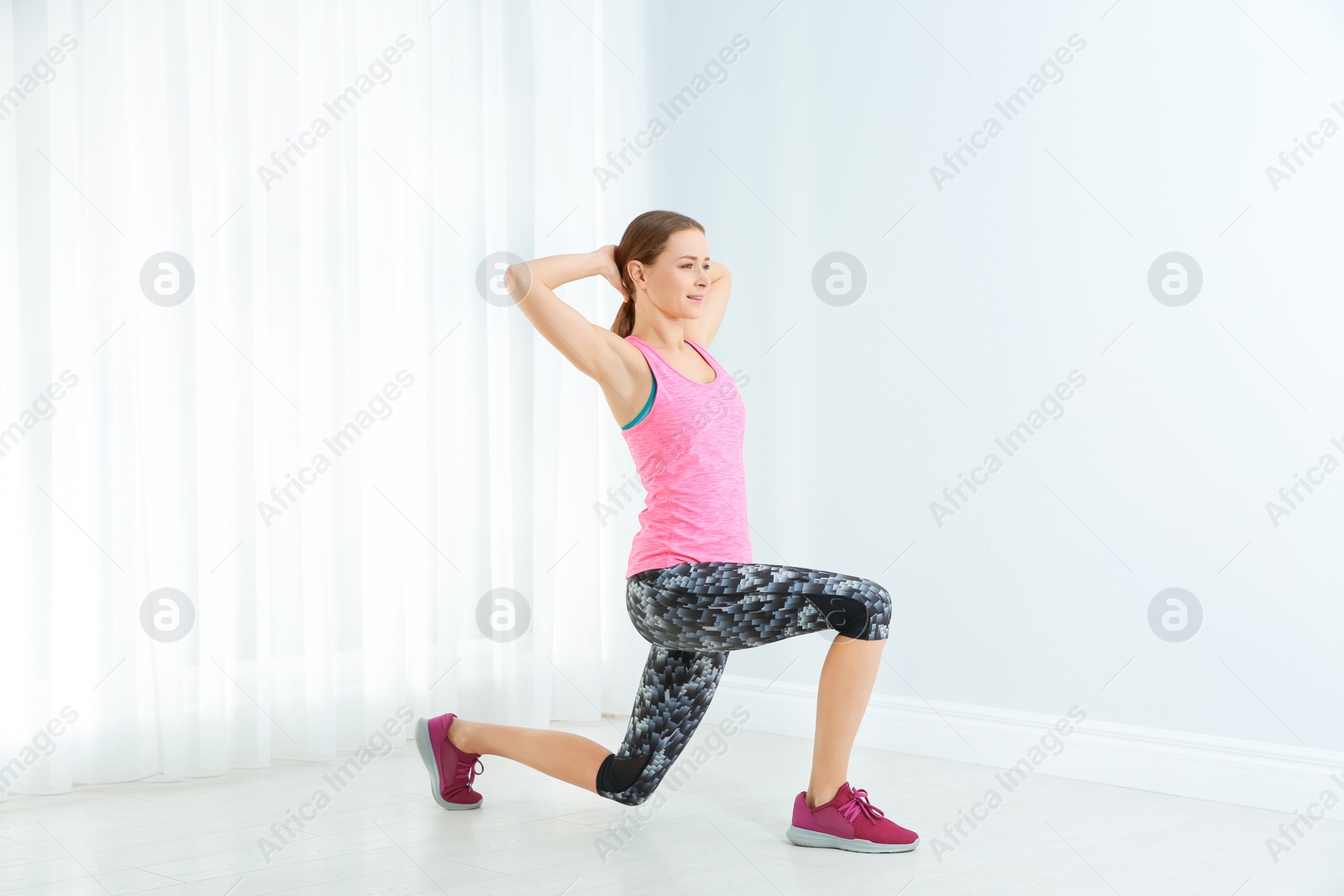 Photo of Young woman doing fitness exercises at home