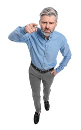 Mature businessman in stylish clothes posing on white background