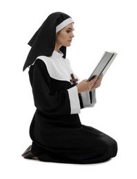 Photo of Young nun reading Bible on white background