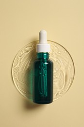 Photo of Bottlecosmetic serum on beige background, top view