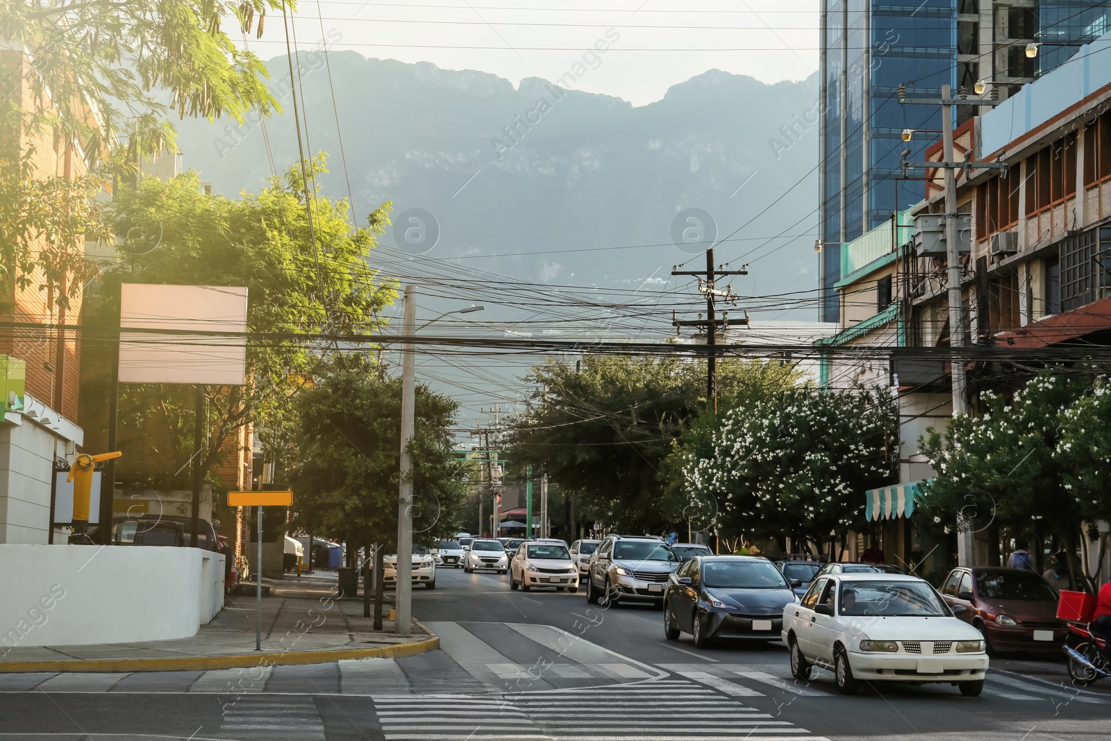 Photo of Picturesque view of city street with cars on road near beautiful buildings