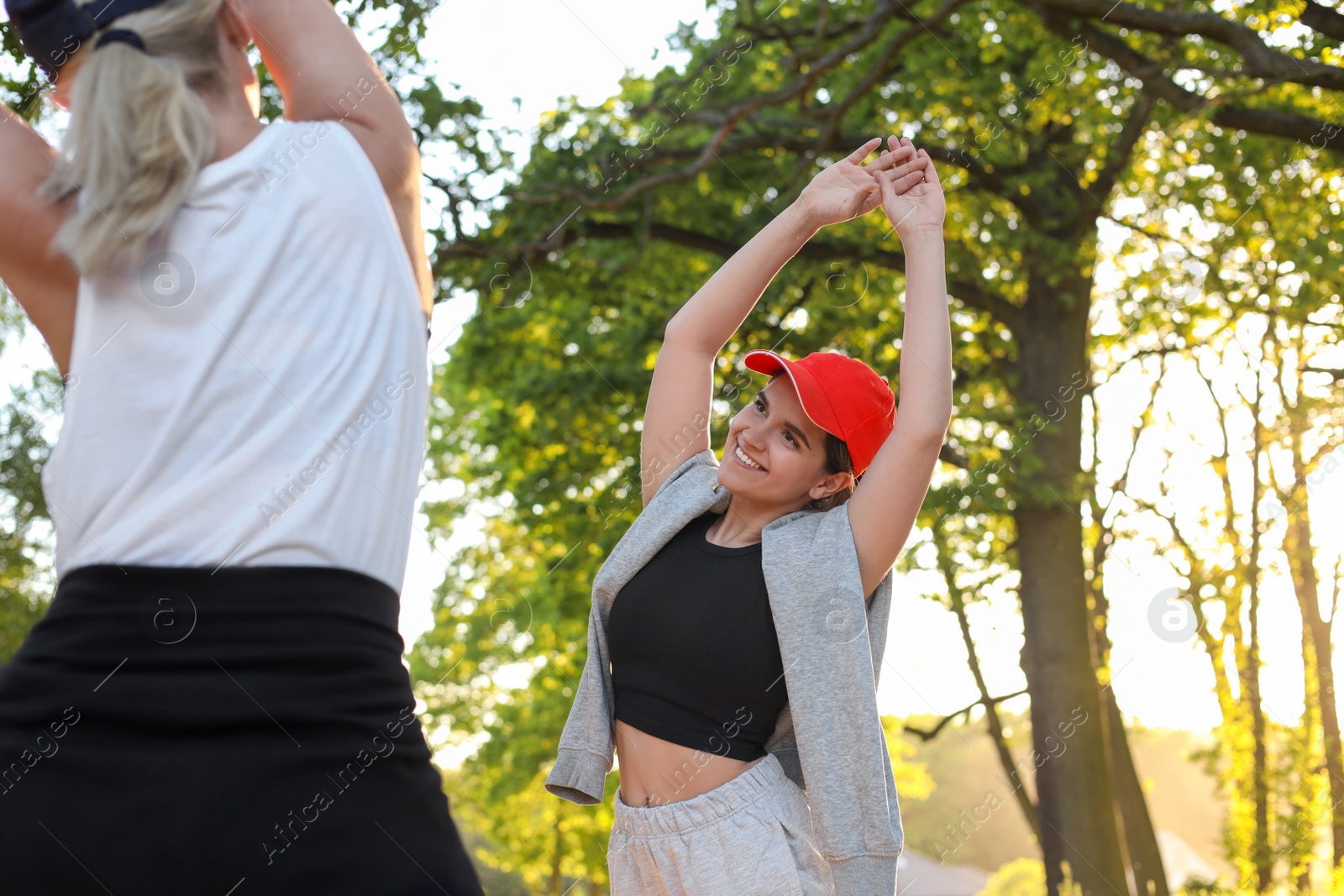 Photo of Women doing morning exercise in park on sunny day