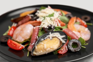 Plate of delicious salad with seafood, closeup view