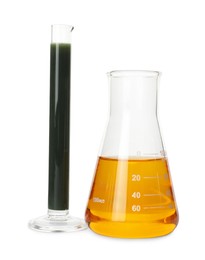 Photo of Test tube and flask with different types of crude oil isolated on white