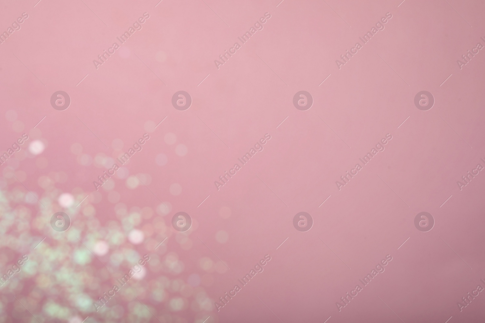 Photo of Blurred view of white glitter on pink background, space for text. Bokeh effect