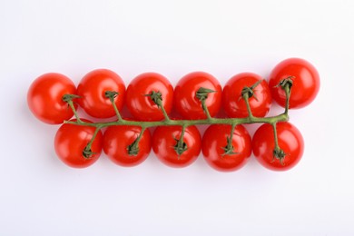 Photo of Vine of red ripe tomatoes on white background, top view