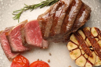 Photo of Delicious grilled beef steak with spices on plate, top view