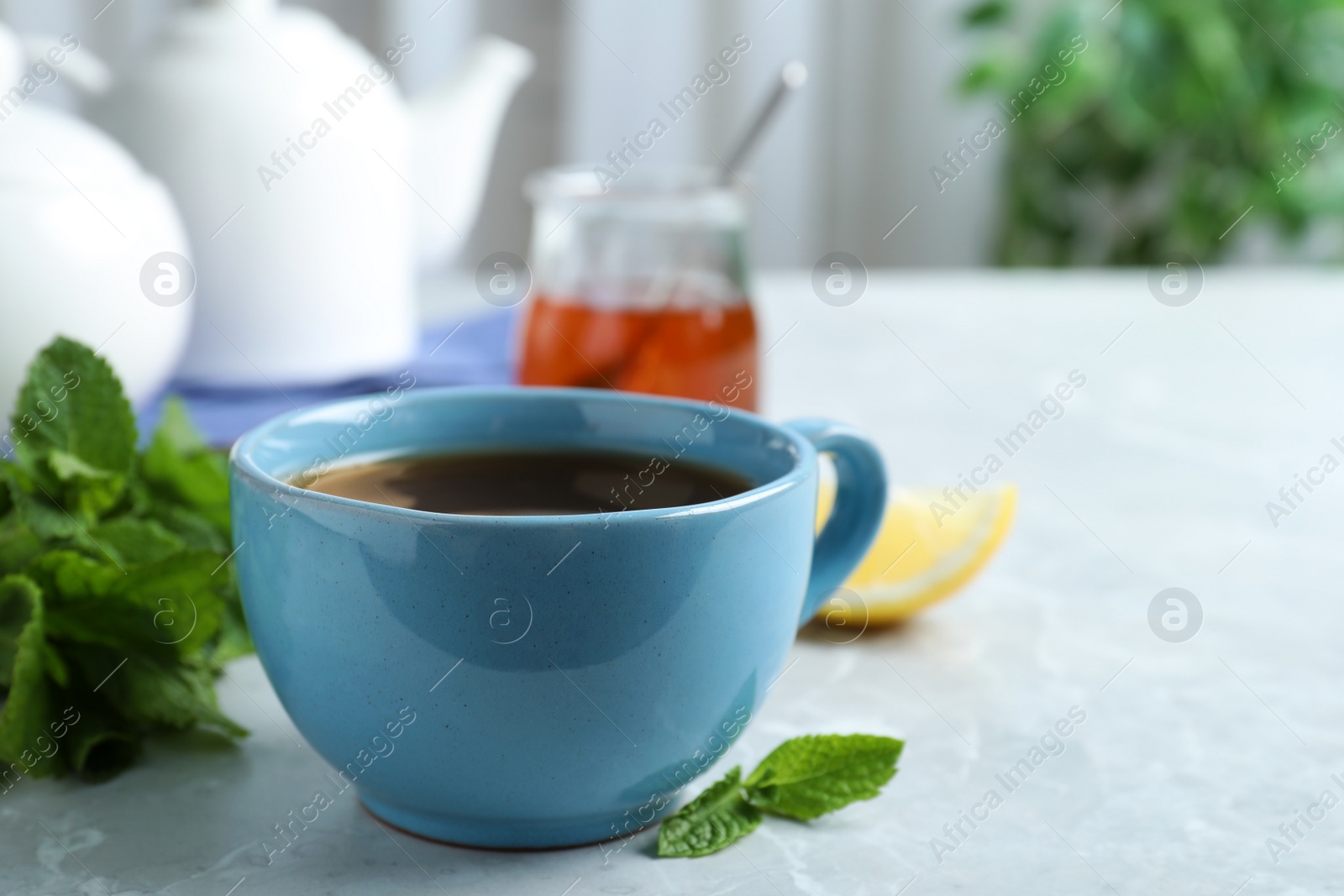 Photo of Fresh tea with mint on light table