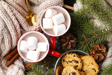 Photo of Cups of tasty cocoa with marshmallows and cookies on tray, flat lay