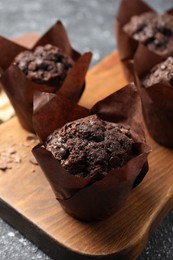 Tasty chocolate muffins on grey table, closeup