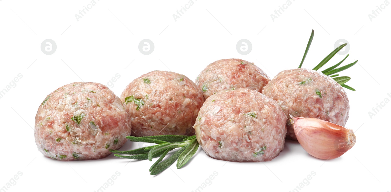 Photo of Many fresh raw meatballs with garlic and rosemary on white background