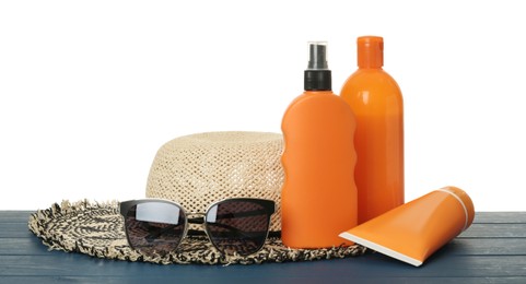 Photo of Sun protection products and beach accessories on blue wooden table