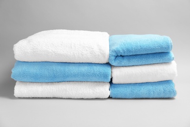 Photo of Soft bath towels on grey background