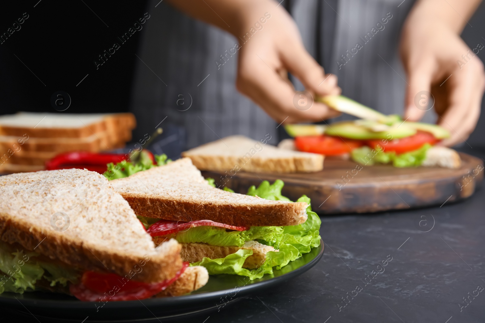 Photo of Tasty sandwiches on black table, closeup view