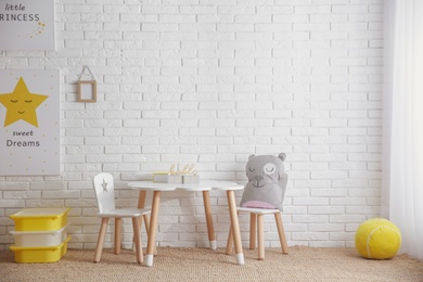 Baby room interior with toys and stylish furniture, space for text