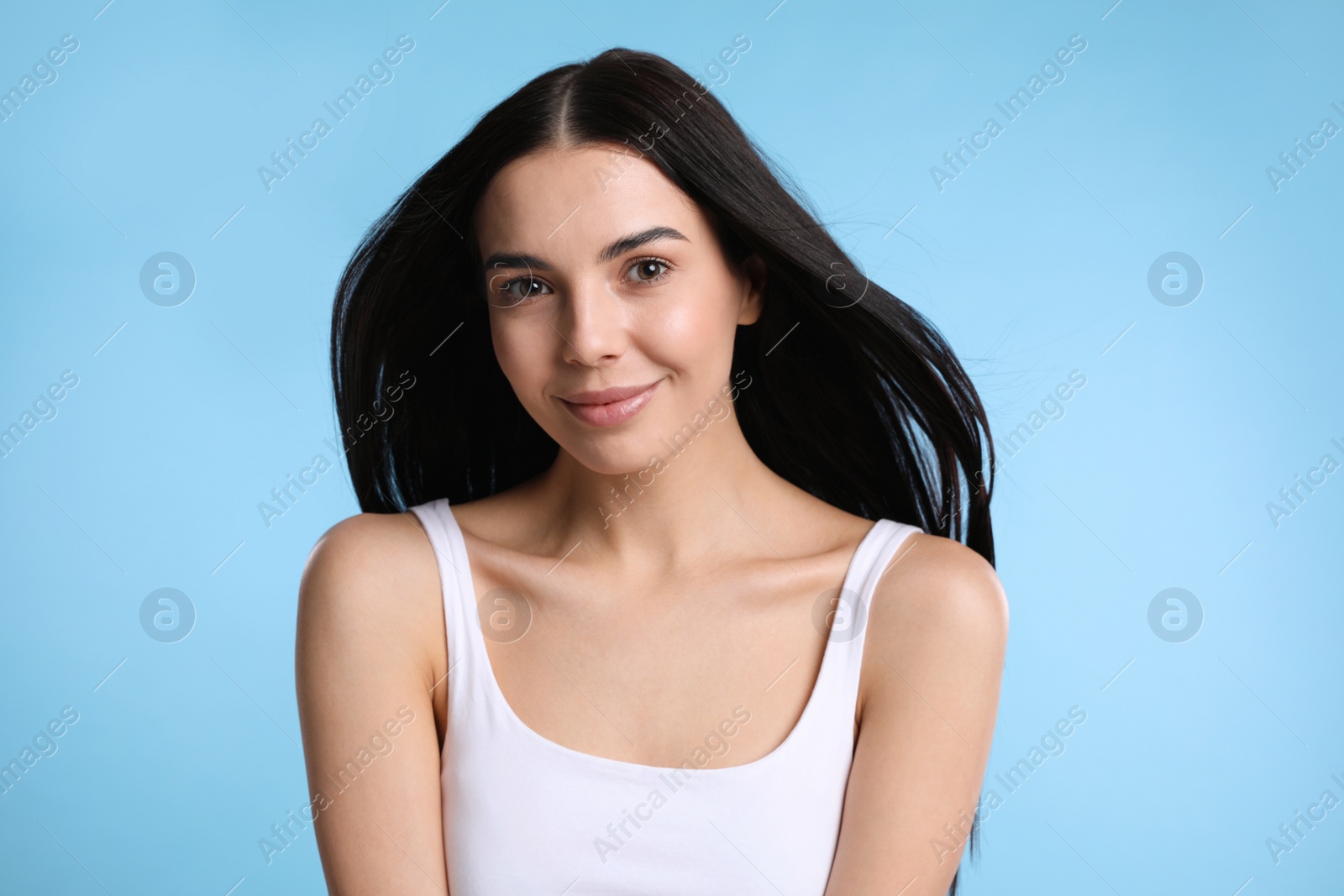 Photo of Portrait of beautiful woman on light blue background