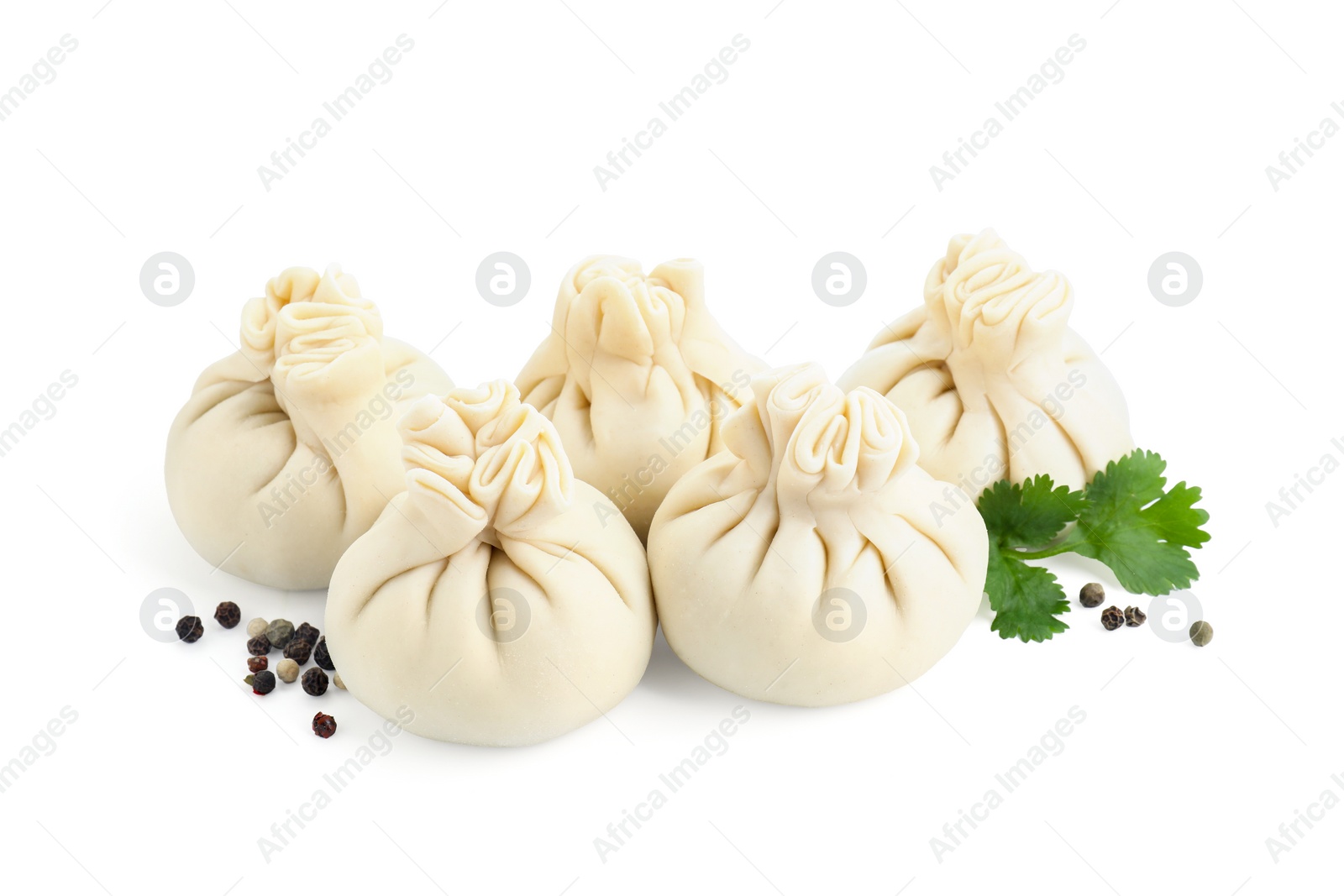 Photo of Uncooked khinkali (dumplings) and spices isolated on white. Georgian cuisine