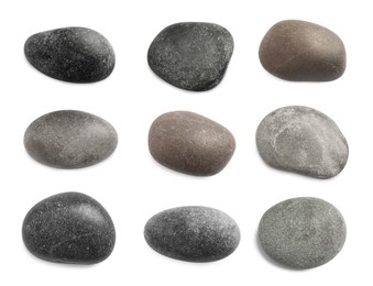 Set with different spa stones on white background