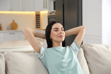 Young woman relaxing on sofa at home