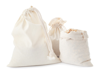 Photo of Cotton eco bags with oat flakes isolated on white