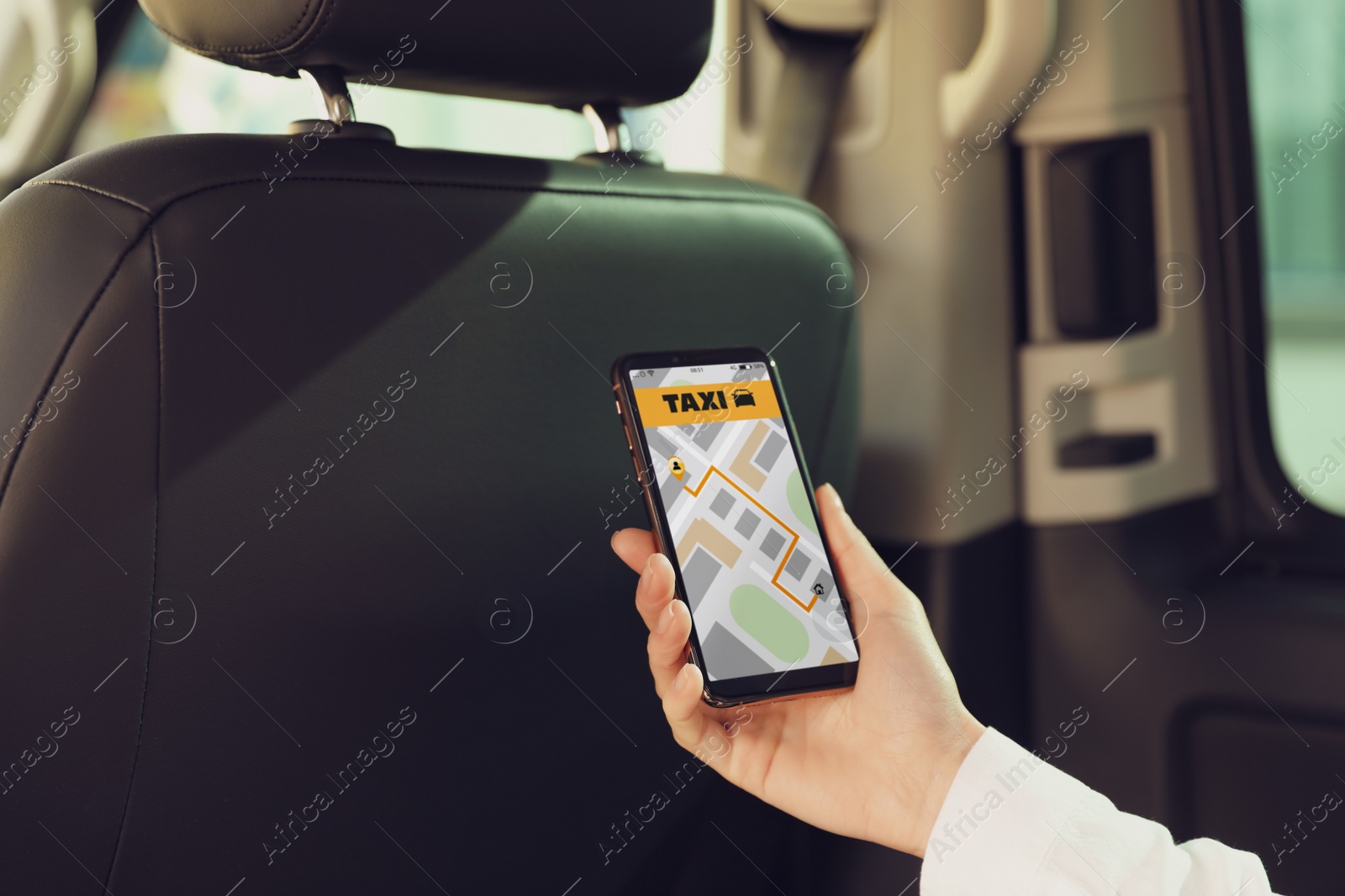 Photo of Woman with mobile phone in taxi salon, closeup