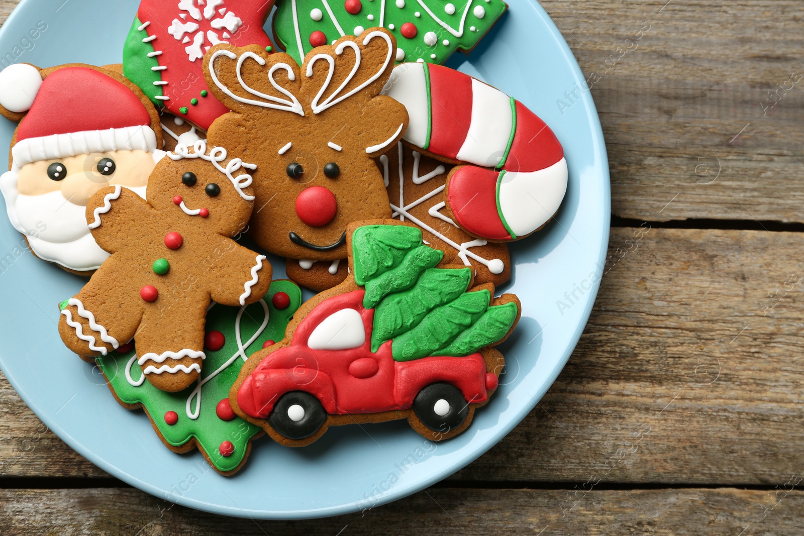 Photo of Different tasty Christmas cookies on wooden table, top view. Space for text