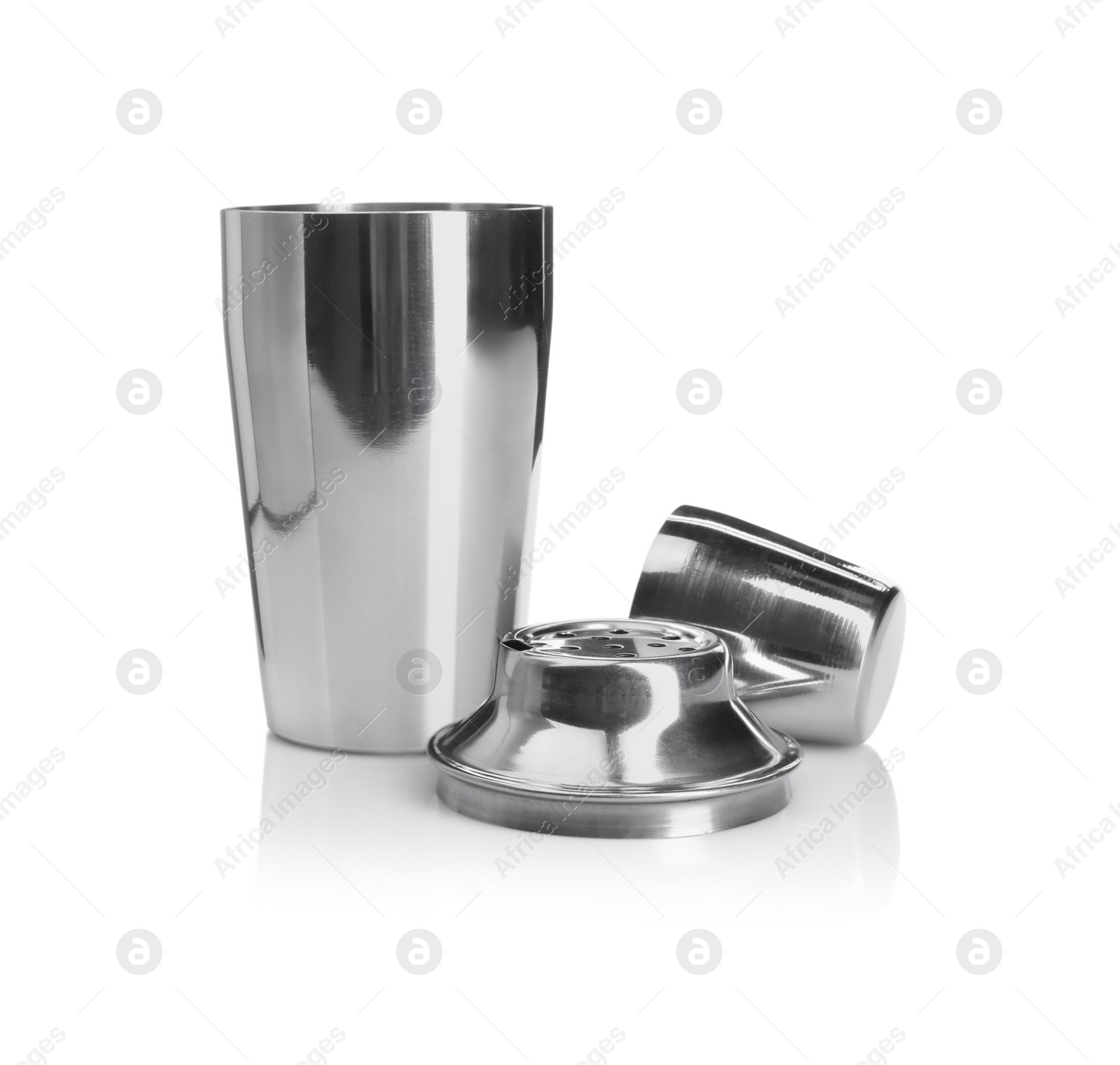 Photo of Metal cocktail shaker, strainer and cup isolated on white