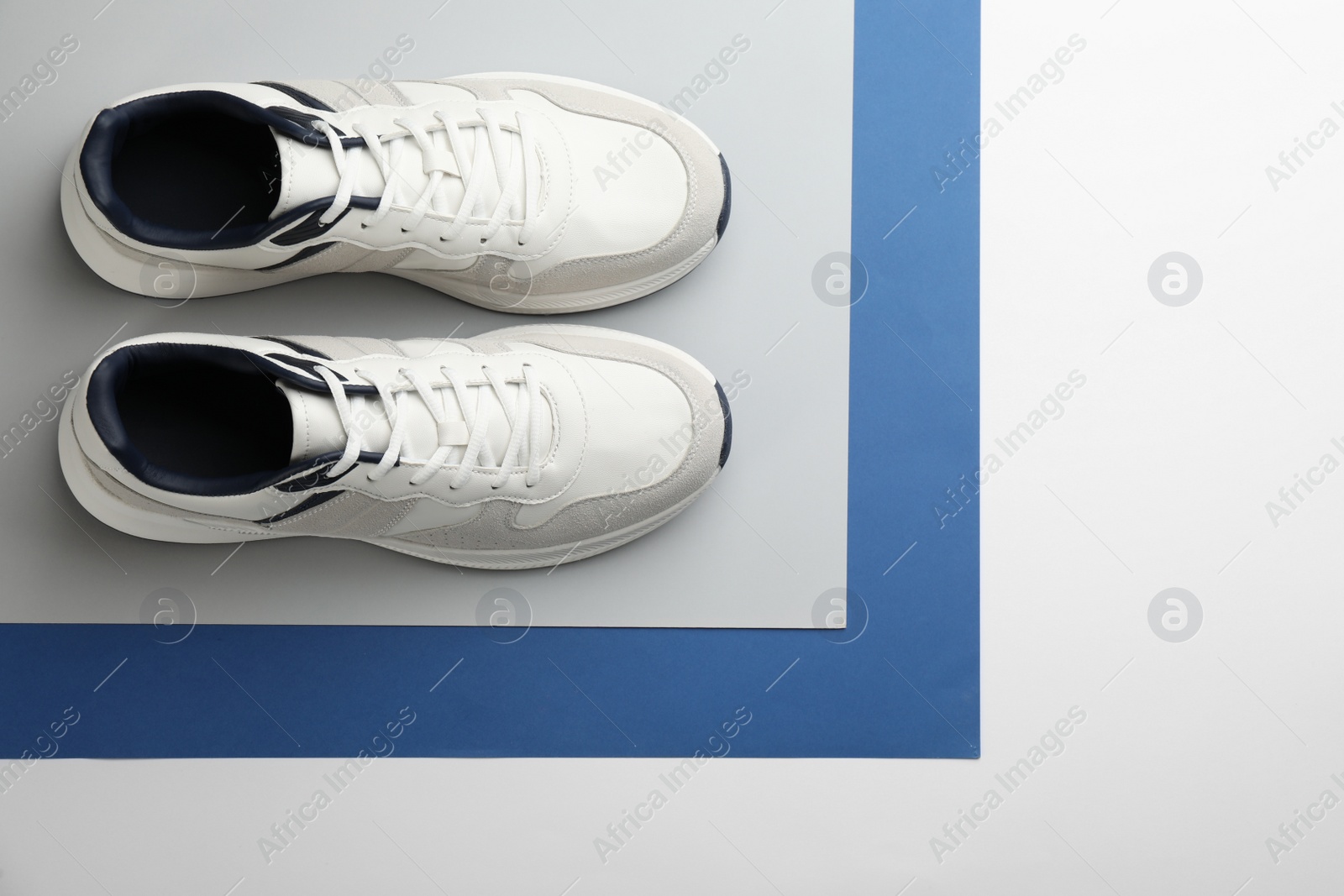 Photo of Pair of stylish sports shoes on color background, flat lay. Space for text