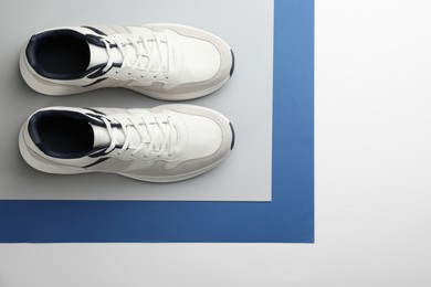 Pair of stylish sports shoes on color background, flat lay. Space for text