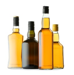 Photo of Different sorts of whiskey in glass bottles isolated on white