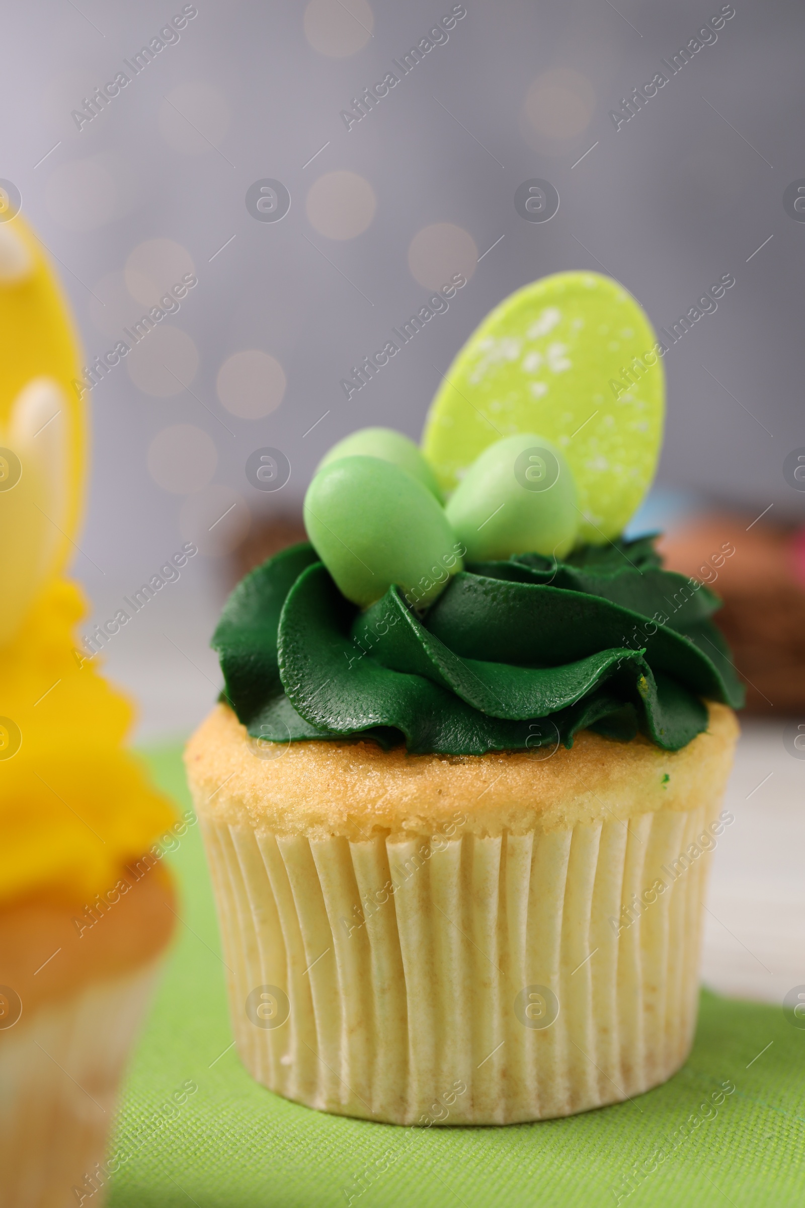 Photo of Tasty cupcake with Easter decor on table, closeup