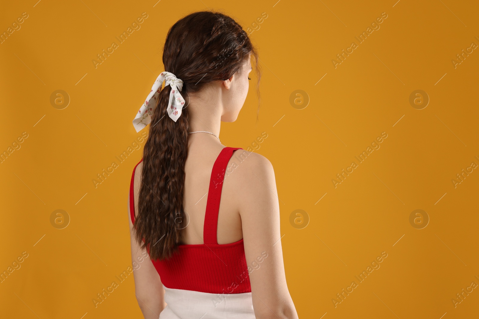 Photo of Woman with stylish bandana on yellow background. Space for text