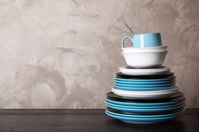 Photo of Set of dinnerware on table against grey background with space for text. Interior element
